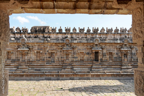 Temple wall with relief carvings. Stone wall of ancient Indian temple of Airavatesvara Temple, Darasuram, Kumbakonam, Tamilnadu. photo