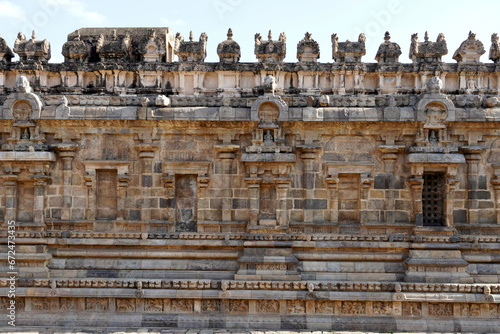 Temple wall with relief carvings. Stone wall of ancient Indian temple of Airavatesvara Temple, Darasuram, Kumbakonam, Tamilnadu. photo