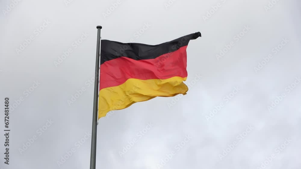 Berlin, Germany - 03. July 2023: A german flag on top of the building of the German Reichstag in Berlin. Berlin, Germany - 03. July 2023: A german flag on top of the building of the German Reichstag in Berlin.