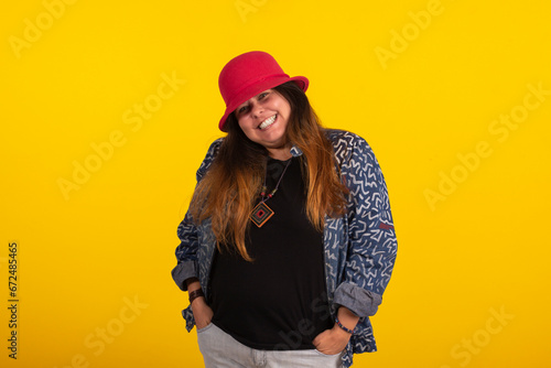 Fat woman wearing red hat in studio photo on yellow background with various facial expressions © EDI