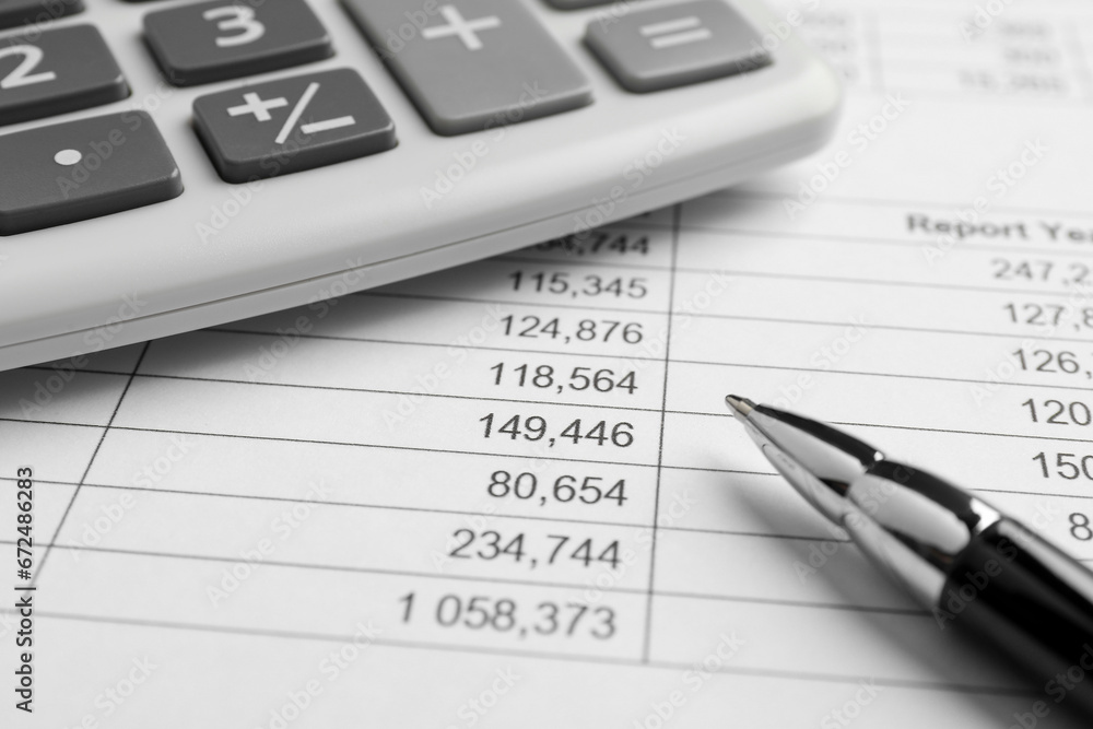 Calculator and pen on documents, closeup view Calculator and pen on documents, closeup view