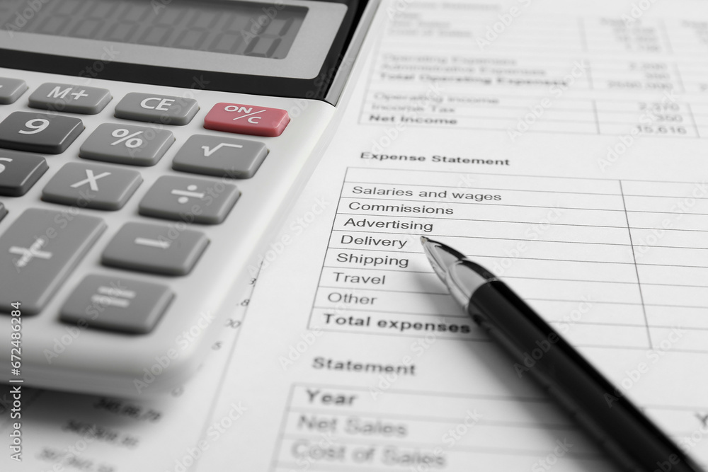 Calculator and pen on documents, closeup view Calculator and pen on documents, closeup view