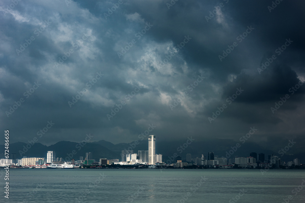 Storm clouds gather over a city, creating a very dramatic landscape Georgetown city, Pulau Pinang Malaysia during the Southwest Monsoon.