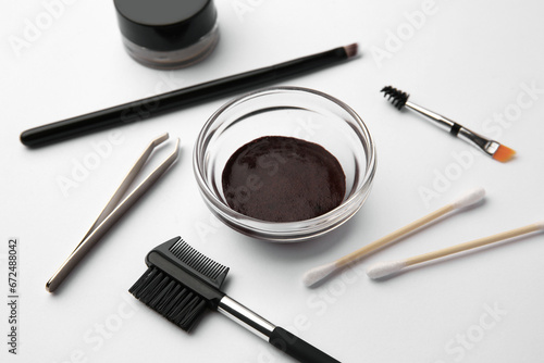 Eyebrow henna and professional tools on white background, closeup