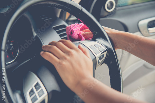 Cleaning car light switch control from the dust using mucrofiber cloth.Cleaning vehicle.