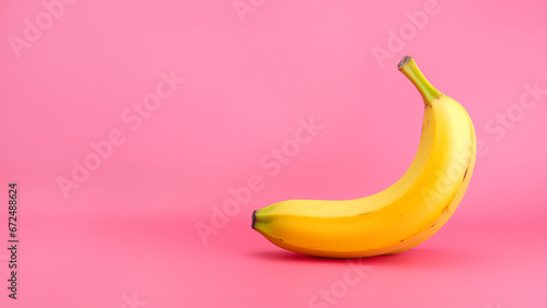 A yellow banana against a pastel pink backdrop background with empty space for text, logo or quote in sharp high 4K resolution showing lots of detail