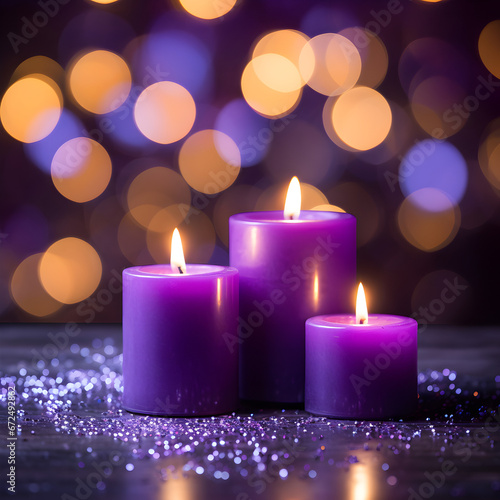 Purple candles with bokeh lights in the background. 
