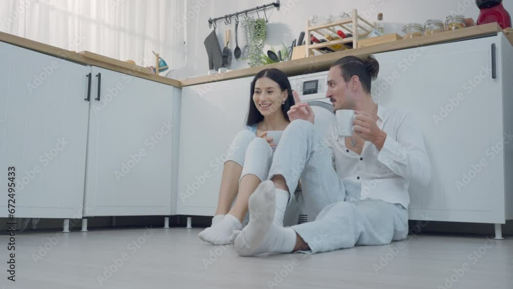 Romantic young couple drinking coffee together in the kitchen, having a great time together in a morning Romantic young couple drinking coffee together in the kitchen, having a great time together in a morning