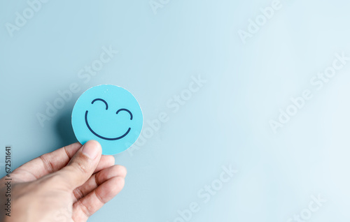 Hands holding happy smile face for medical care concept. mental health positive thinking.