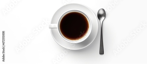 White cup of coffee with spoon and saucer seen from above on a white background