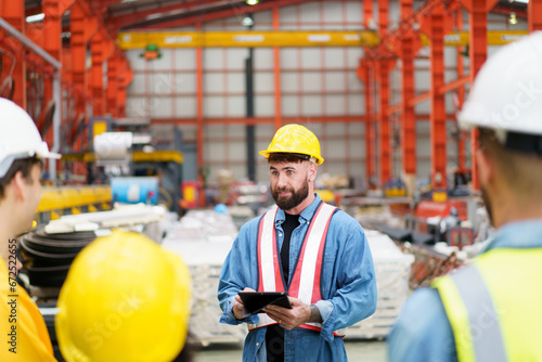 Group of diversity factory engineer team having a discussion in morning brief.