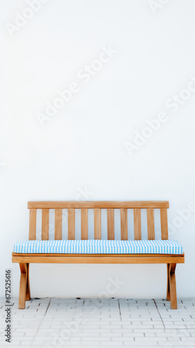 a wooden bench with a blue and white striped cushion