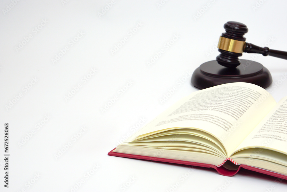 Close up law book and blurred the judge gavel or hammer placed behind. Law, judiciary concept. Close up law book and blurred the judge gavel or hammer placed behind. Law, judiciary concept.