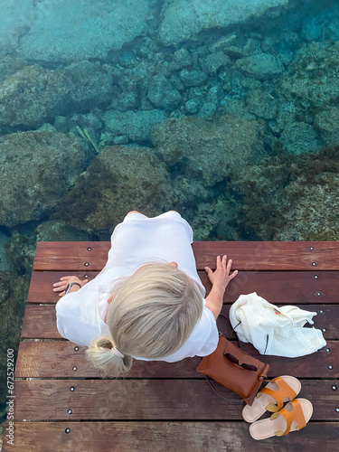 person relaxing on a pier