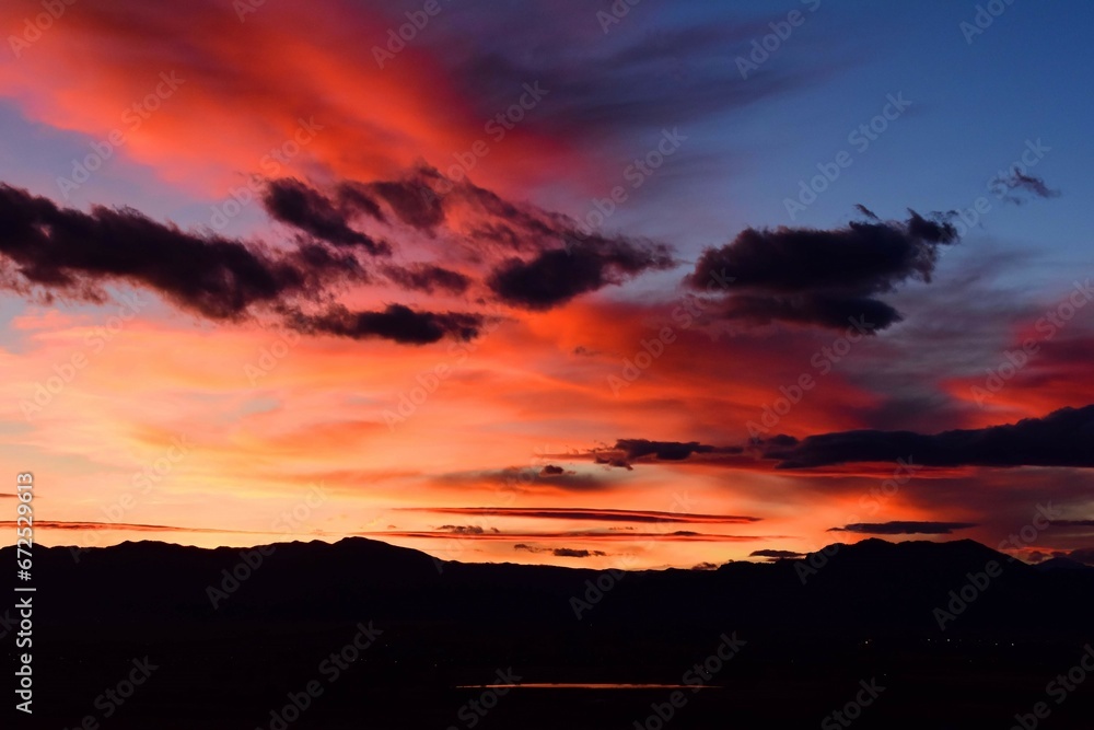 Colorful sunset over stearns lake and the front range of the colorado rocky mountains as seen from broomfield, colorado