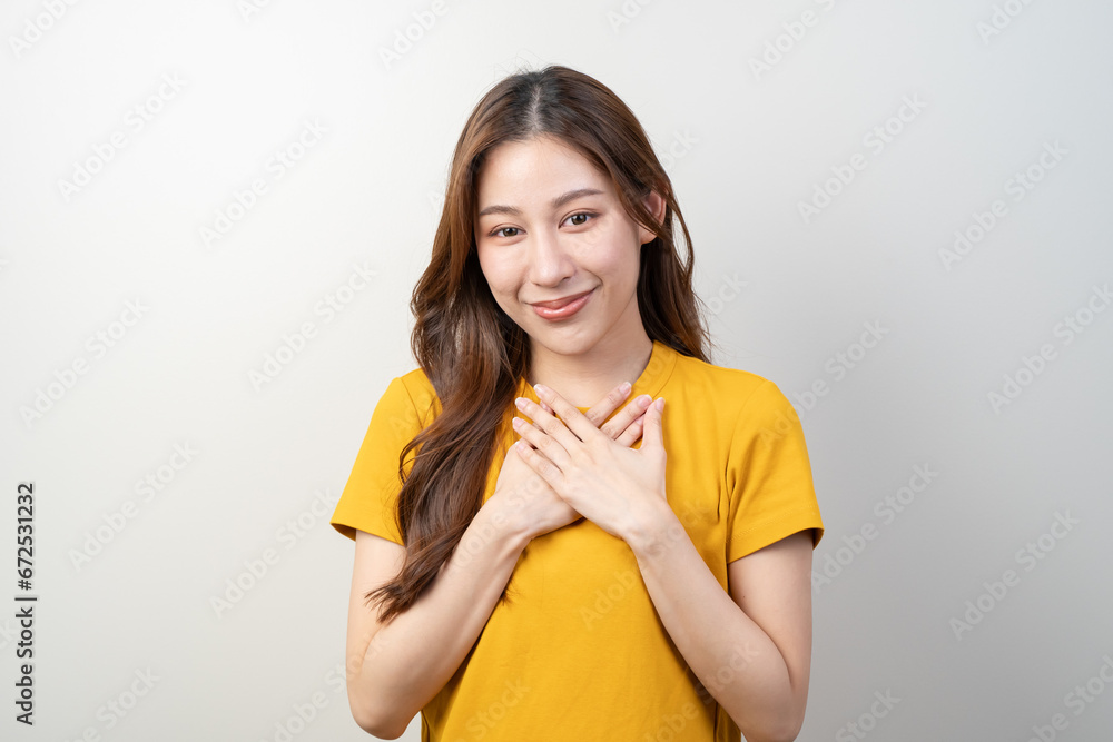 Happy young female with a smile face putting her hands on her chest and feel appreciated. Happy young female with a smile face putting her hands on her chest and feel appreciated.