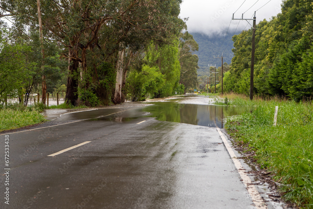 Flood Water over a country road in Warburton, Victoria Australia 2023