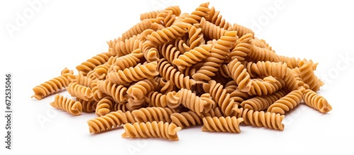 Whole grain fusilli pasta photographed on a white background photo