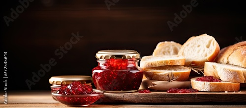 The tray on the table contains wood with jam and bread placed on it