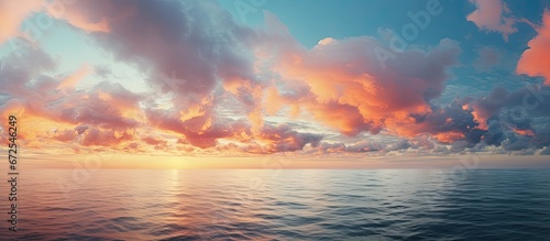 The sunset over the ocean showcases striking clouds