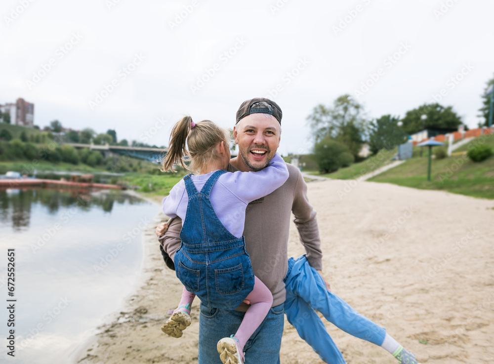 family dad and little daughters play on the beach family dad and little daughters play on the beach