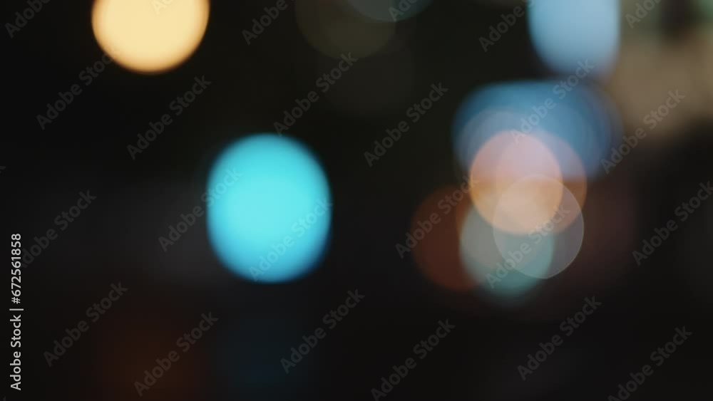 Bokeh background of night city with car light passing by Bokeh background of night city with car light passing by