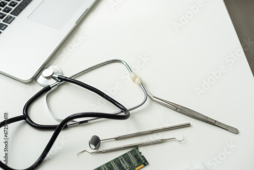 Laptop, glasses and stethoscope kept on doctor's table.