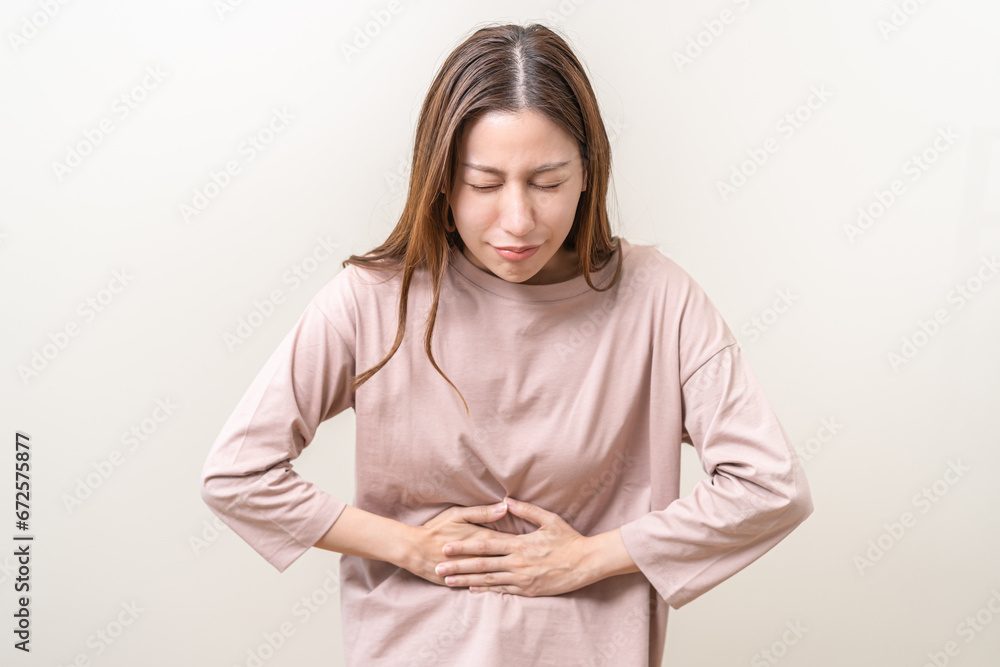 Flatulence asian young woman intolerance hand in stomach ache, suffer from food poisoning, abdominal pain and colon problem, gastritis or diarrhoea when at home. Patient belly, abdomen or inflammation Flatulence asian young woman intolerance hand in stomach ache, suffer from food poisoning, abdominal pain and colon problem, gastritis or diarrhoea when at home. Patient belly, abdomen or inflammation