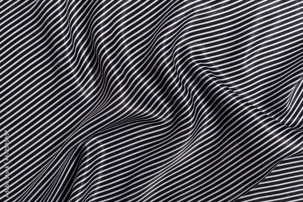 texture of crumpled, wrinkled silk fabric of white and black striped color. the concept of materials for sewing clothes and a marine theme. Image for your design