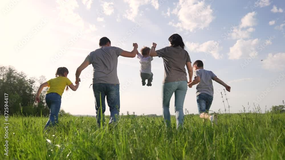 Happy family concept. family outdoor hike in forest park. picnic in nature on green grass at sunset. portrait of a happy family on picnic. children and parents have fun in a forest park on green grass Happy family concept. family outdoor hike in forest park. picnic in nature on green grass at sunset. portrait of a happy family on picnic. children and parents have fun in a forest park on green grass