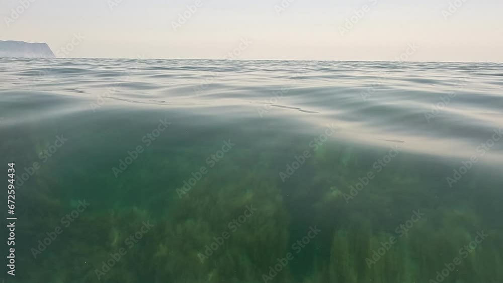 Sea water surface background. Low angle view from kayak, camera flies over the clear green sea water. Nobody. Holiday recreation concept. Abstract nautical summer ocean nature. Slow motion. Sea water surface background. Low angle view from kayak, camera flies over the clear green sea water. Nobody. Holiday recreation concept. Abstract nautical summer ocean nature. Slow motion.