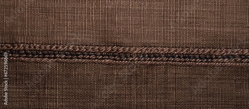 Two pieces of fabric decorated with topstitching create a textured surface resembling brown denim