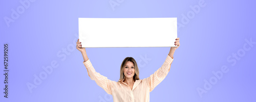 Smiling woman standing with empty mock up banner, purple background