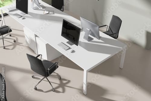 Top view of office workplace interior with pc desktop and armchairs photo