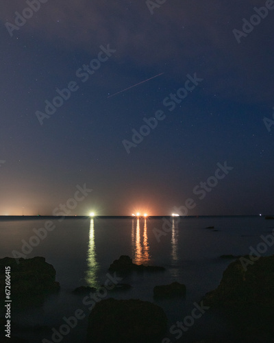 A night time shot of lights on the other side of a large body of water
