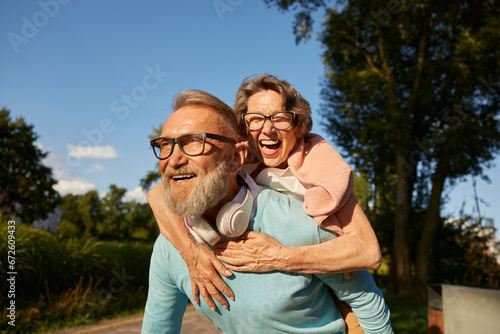 Happy active senior couple having fun outdoor in city park
