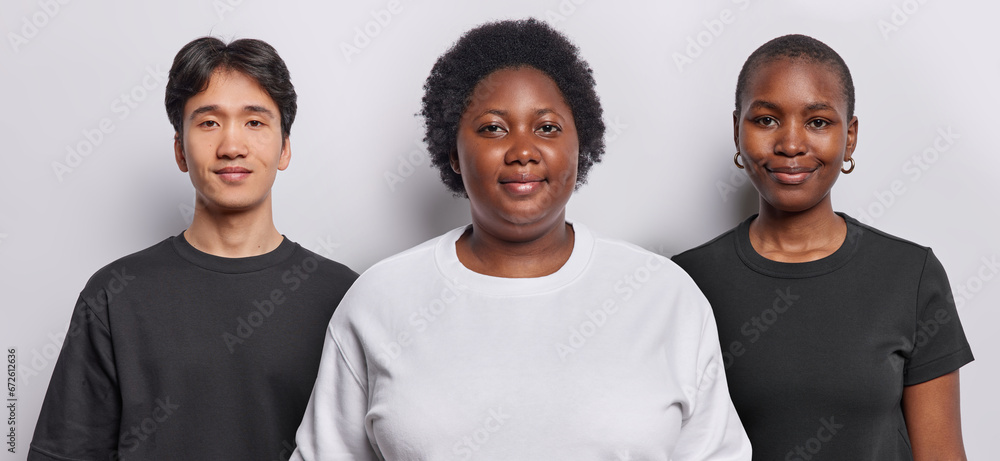 Photo collage of three people with calm confident expressions look directly at camera dressed in casual clothing pose against white background in studio. Dark skinned African plump woman with friends - obrazy, fototapety, plakaty 
