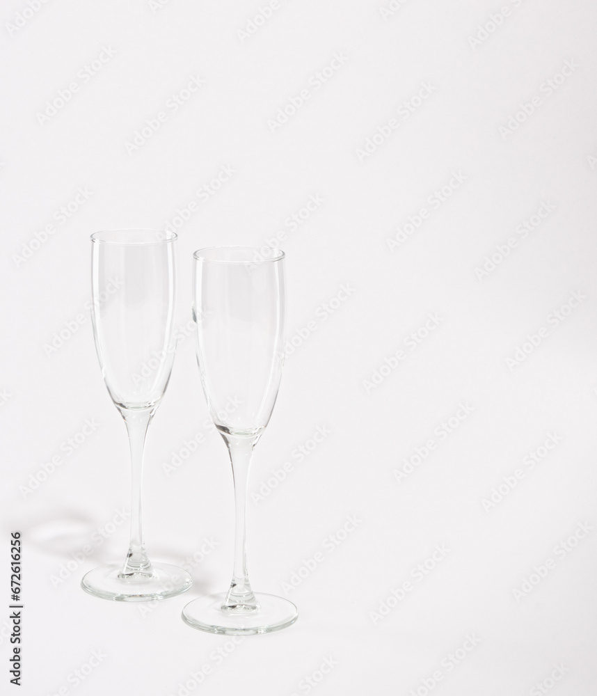 Two empty wine or champagne glasses isolated on white background. Copy space for text. Enjoying romantic weekend.