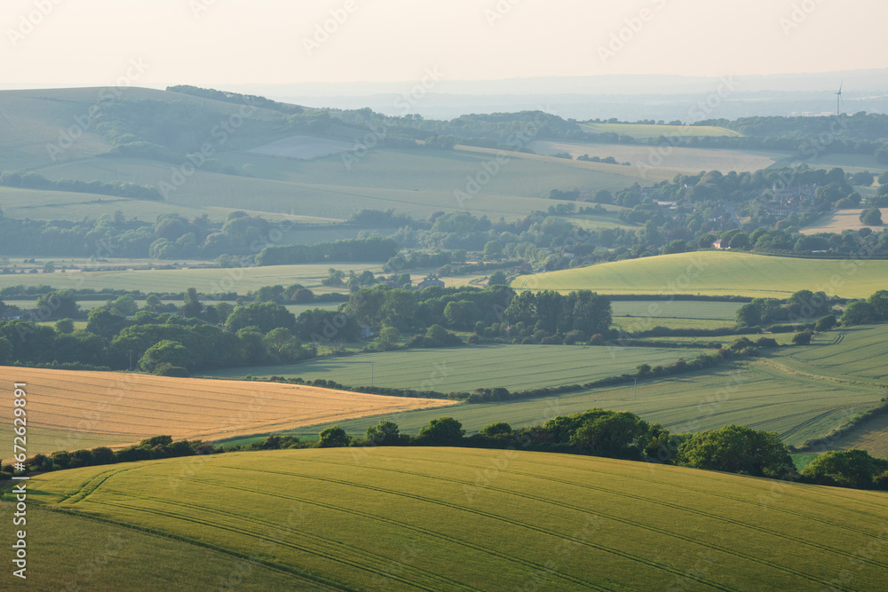 Stunning Summer sunset from Firle Beacon in South Downs National Park in beautiful English countryside