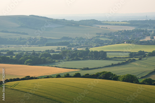 Stunning Summer sunset from Firle Beacon in South Downs National Park in beautiful English countryside