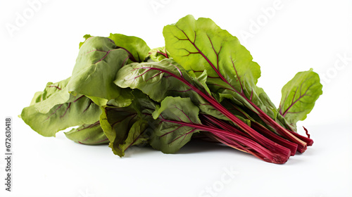 a bunch of green and red beets on a white surface