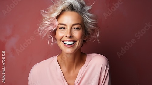 Beautiful mid age woman with grey hair. Laughing and smiling. Pink background. Nature lady close up portrait. Healthy face skin care beauty, skincare cosmetics. High quality