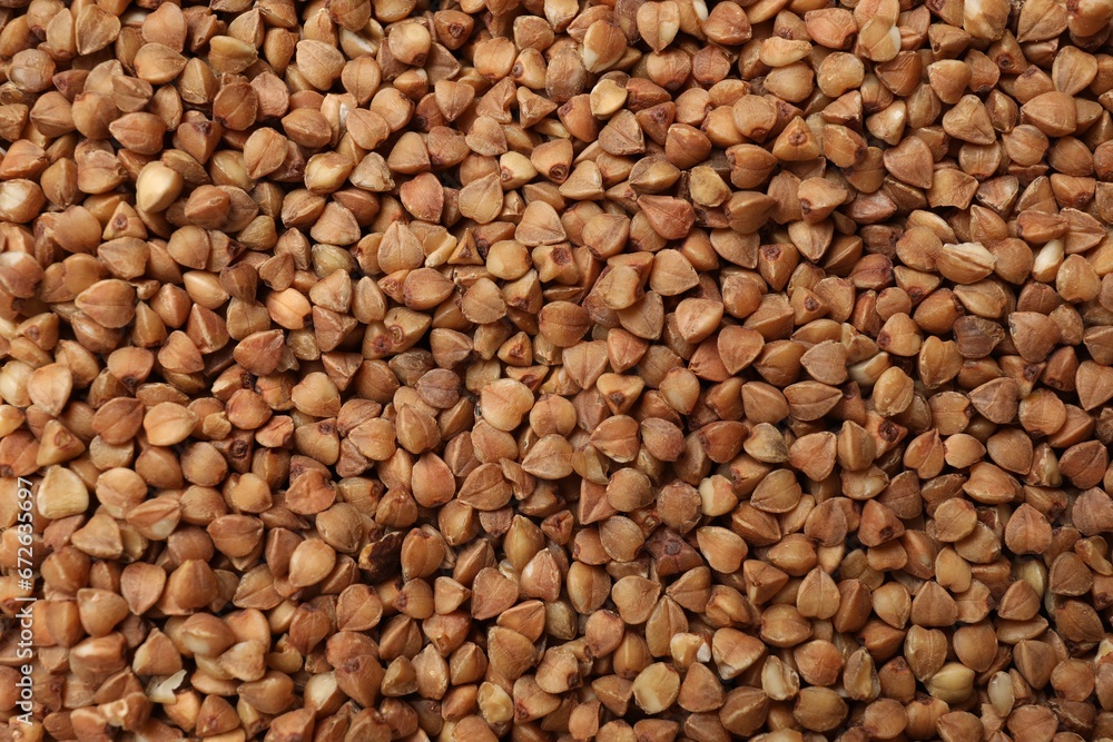 Dry buckwheat grains as background, top view Dry buckwheat grains as background, top view