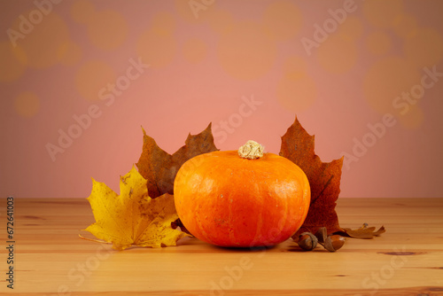 Autumn still life with pumpkins  leaves and acorns on wooden table