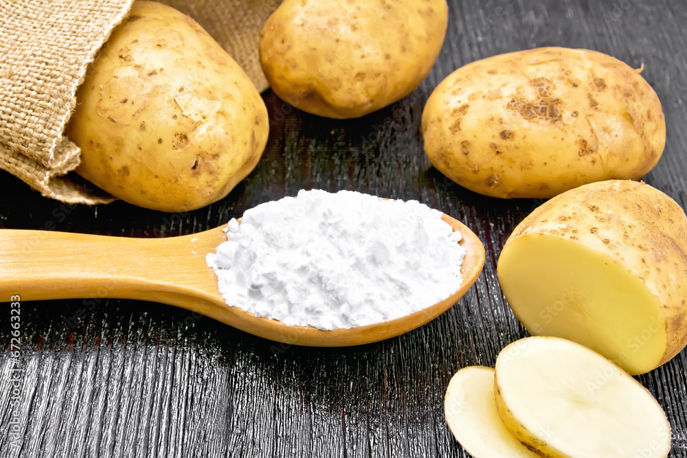 Starch potato in spoon on wooden board Starch potato in spoon on wooden board