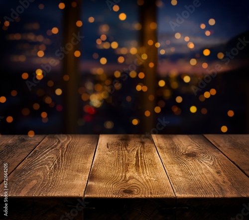 Festive, Christmas, New Year background. Evening. Night. Homely, cozy background. Abstract background. A wooden table on the background of a window with a night view and golden garlands. Bokeh. 