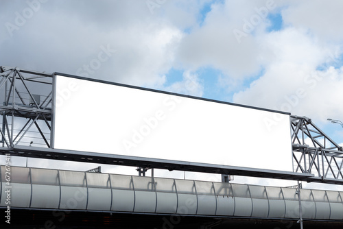 Long horizontal billboard on metal truss structure on cloudy sky background. Mock-up.