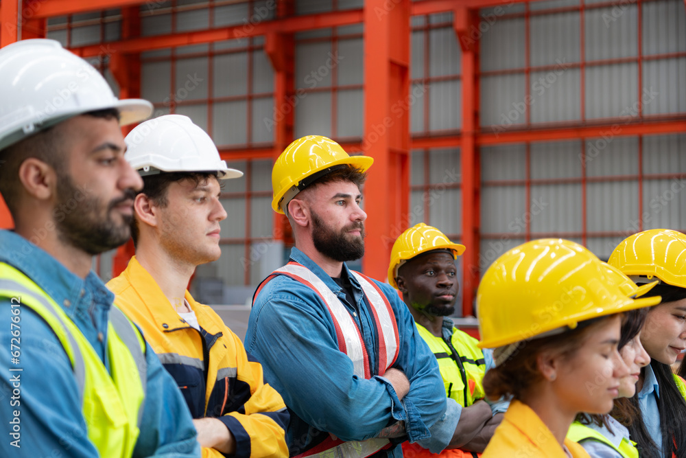 Portrait of engineers and industrial workers in hardhats at construction site Portrait of engineers and industrial workers in hardhats at construction site