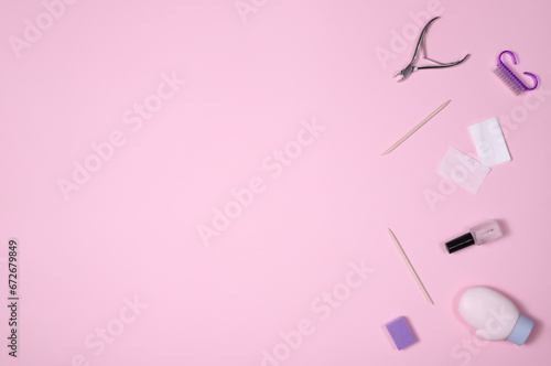 Professional manicure set on a pink background. The concept of hand care, salon procedures. Top view.