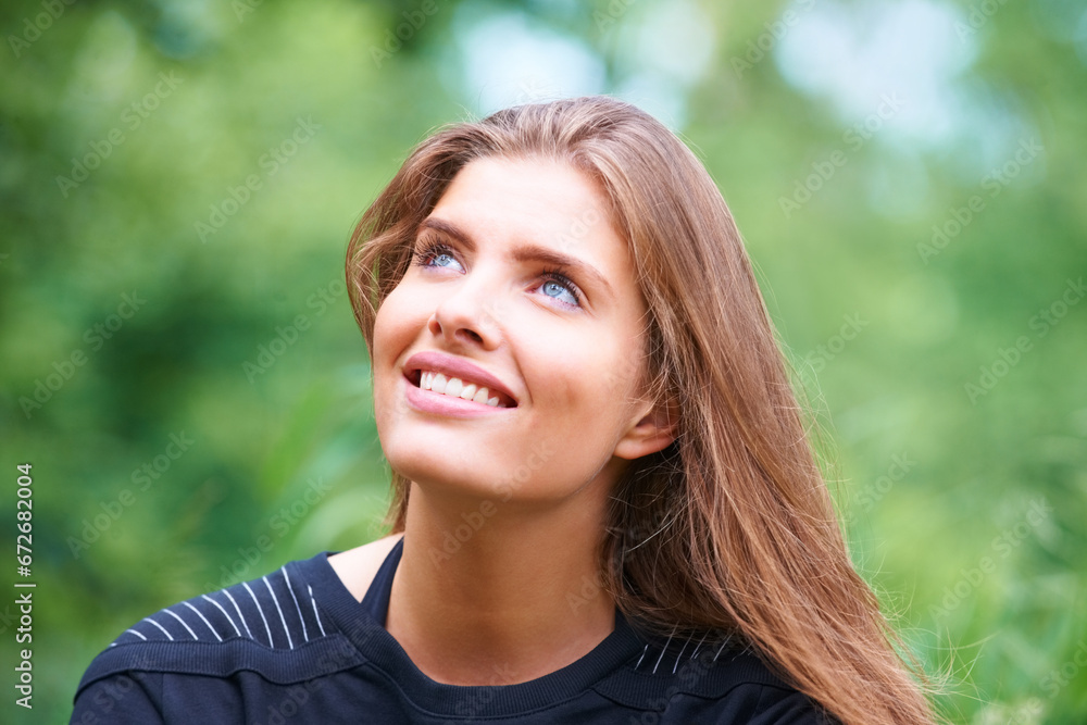 Park, happy woman or thinking outdoors to relax on a holiday vacation in summer or nature. Face, looking up or thoughtful female person on break for ideas or mindfulness for scenic travel in forest